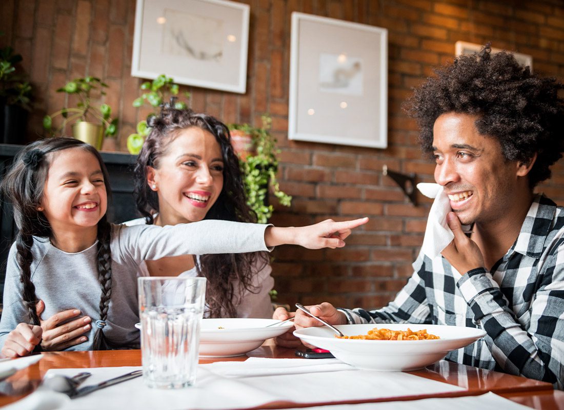 Contact - Happy Family Eating Lunch Together at Restaurant and Having Fun