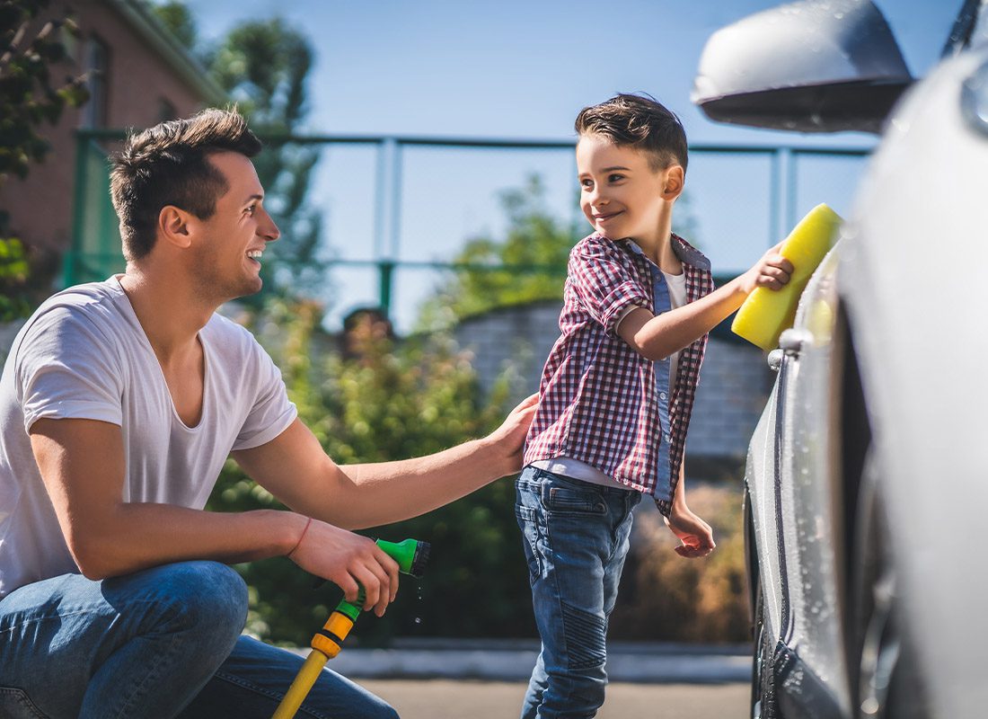 Personal Insurance - Father With His Son Washing the Family Car on a Summer Day
